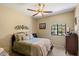 Cozy bedroom with neutral walls, a ceiling fan, and comfortable furnishings at 4136 E Greenway Cir, Mesa, AZ 85205
