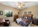Comfortable bedroom with ceiling fan, neutral walls, window, and cozy decor at 4136 E Greenway Cir, Mesa, AZ 85205