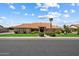 Charming single-story home with a red tile roof, manicured landscaping, and a palm tree in the front yard at 4136 E Greenway Cir, Mesa, AZ 85205