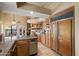 Functional kitchen featuring custom wood cabinetry, stone countertops, and stainless steel appliances at 4136 E Greenway Cir, Mesa, AZ 85205