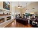 Open living space featuring a fireplace, built-in shelving, hardwood floors, and high vaulted ceilings at 4136 E Greenway Cir, Mesa, AZ 85205