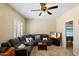 Comfortable living room with sectional sofa, ceiling fan, and media setup at 4136 E Greenway Cir, Mesa, AZ 85205