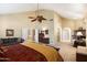 Spacious main bedroom with vaulted ceilings, ceiling fan, sitting area, and ensuite bathroom at 4136 E Greenway Cir, Mesa, AZ 85205