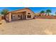 Spacious backyard featuring low-maintenance gravel landscaping and a covered patio at 42196 W Chisholm Dr, Maricopa, AZ 85138
