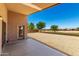 A large, gravel-covered backyard with an extended patio and desert landscaping at 42196 W Chisholm Dr, Maricopa, AZ 85138