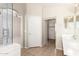 Bathroom featuring tile floors, double sinks, and doorway leading to carpeted bedroom at 42196 W Chisholm Dr, Maricopa, AZ 85138