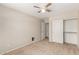 Bedroom featuring carpet floors, ceiling fan, closet, and interior door at 42196 W Chisholm Dr, Maricopa, AZ 85138