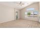 Spacious carpeted bedroom features vaulted ceiling, ceiling fan, and natural light at 42196 W Chisholm Dr, Maricopa, AZ 85138