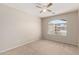 Neutral bedroom with carpet floors and lots of natural light from large window at 42196 W Chisholm Dr, Maricopa, AZ 85138