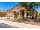 Charming single-story home with a two-car garage and desert landscaping at 42196 W Chisholm Dr, Maricopa, AZ 85138