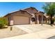 Charming single-story home with a two-car garage and desert landscaping at 42196 W Chisholm Dr, Maricopa, AZ 85138