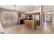 The kitchen features stainless steel appliances, an island and adjacent dining area, offering a seamless flow at 42196 W Chisholm Dr, Maricopa, AZ 85138