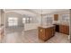 Bright kitchen features an island with room for seating and access to the backyard at 42196 W Chisholm Dr, Maricopa, AZ 85138