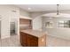 Open kitchen boasts an island and adjacent dining area, offering a seamless flow and ample space at 42196 W Chisholm Dr, Maricopa, AZ 85138