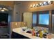 Bathroom with a sink, soaking tub, vanity mirror, and open access to bedroom at 43418 W Wild Horse Trl, Maricopa, AZ 85138
