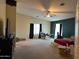 Spacious bedroom featuring ceiling fan, a window, and carpeted floors at 43418 W Wild Horse Trl, Maricopa, AZ 85138