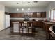 Kitchen with island, seating, stainless steel microwave, and lots of cabinet space at 43418 W Wild Horse Trl, Maricopa, AZ 85138
