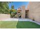 Backyard with artificial grass, a paved patio and desert landscaping at 4434 E Camelback Rd # 132, Phoenix, AZ 85018