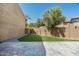 Backyard with artificial grass, a paved patio, and low-maintenance desert landscaping at 4434 E Camelback Rd # 132, Phoenix, AZ 85018