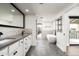 Modern bathroom featuring double vanity, soaking tub, and tiled walls at 4434 E Camelback Rd # 132, Phoenix, AZ 85018