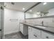 Modern bathroom with double vanity, large mirror, and shower with glass enclosure at 4434 E Camelback Rd # 132, Phoenix, AZ 85018
