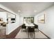 Dining room with marble-top table and seating for six, next to living room at 4434 E Camelback Rd # 132, Phoenix, AZ 85018
