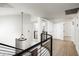 Second story hallway with wood floors, black metal railing, and modern light fixture at 4434 E Camelback Rd # 132, Phoenix, AZ 85018