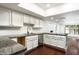 Bright kitchen featuring granite countertops, white cabinets, and stainless steel appliances at 4434 E Camelback Rd # 132, Phoenix, AZ 85018