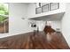 Bright living room featuring hardwood floors, staircase, and views into the kitchen at 4434 E Camelback Rd # 132, Phoenix, AZ 85018