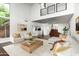 Open living room with dark wood floors, white furniture, staircase and high ceilings at 4434 E Camelback Rd # 132, Phoenix, AZ 85018