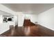 Open-concept living area with gorgeous wood flooring, neutral walls, and direct access to the staircase at 4434 E Camelback Rd # 132, Phoenix, AZ 85018