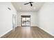 Spacious living room featuring a ceiling fan and a sliding glass door leading to the balcony at 4434 E Camelback Rd # 132, Phoenix, AZ 85018