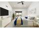 Comfortable main bedroom featuring a ceiling fan, TV, and sliding glass doors to the outdoors at 4434 E Camelback Rd # 132, Phoenix, AZ 85018