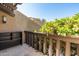 Cozy patio area with wooden railing and lush greenery at 4434 E Camelback Rd # 132, Phoenix, AZ 85018