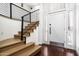 Modern wood staircase showcasing black iron railings and leading to an upper floor at 4434 E Camelback Rd # 132, Phoenix, AZ 85018