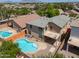 An aerial shot of this home showcasing the inviting pool and the home's proximity to the surrounding neighborhood at 45113 W Buckhorn Trl, Maricopa, AZ 85139