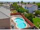 An aerial view of a private backyard oasis with a sparkling pool surrounded by desert landscaping at 45113 W Buckhorn Trl, Maricopa, AZ 85139