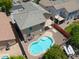 Overhead drone shot of a backyard with a sparkling pool, patio, and desert landscaping in a residential neighborhood at 45113 W Buckhorn Trl, Maricopa, AZ 85139