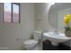 This bathroom features a modern sink, commode, and window at 45113 W Buckhorn Trl, Maricopa, AZ 85139