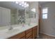 Bathroom with double sinks, large mirror, and cabinets at 45113 W Buckhorn Trl, Maricopa, AZ 85139