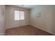 This cozy bedroom features neutral paint, carpet, and a window with wood blinds at 45113 W Buckhorn Trl, Maricopa, AZ 85139