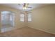 Bedroom with neutral carpet and walls, large archway to an adjacent room at 45113 W Buckhorn Trl, Maricopa, AZ 85139