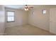 This bedroom features plush carpet and windows that allow natural light to fill the space at 45113 W Buckhorn Trl, Maricopa, AZ 85139