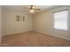 Spacious bedroom featuring neutral walls, carpeted floors, and a ceiling fan at 45113 W Buckhorn Trl, Maricopa, AZ 85139