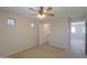 A well-lit bedroom features two side windows, a closet, and a ceiling fan at 45113 W Buckhorn Trl, Maricopa, AZ 85139