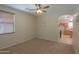 Bedroom with neutral colored walls and carpeting and an archway to another room at 45113 W Buckhorn Trl, Maricopa, AZ 85139