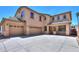 Beautiful two-story house featuring a stucco exterior, three-car garage, and inviting front porch at 45113 W Buckhorn Trl, Maricopa, AZ 85139