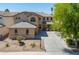 Beautiful two-story home with a well-manicured front yard and long driveway leading to a 3-car garage at 45113 W Buckhorn Trl, Maricopa, AZ 85139