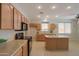 Bright kitchen with light cabinets, island and granite countertops at 45113 W Buckhorn Trl, Maricopa, AZ 85139