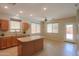 Bright eat-in kitchen features an island, tile floors and view to the backyard at 45113 W Buckhorn Trl, Maricopa, AZ 85139